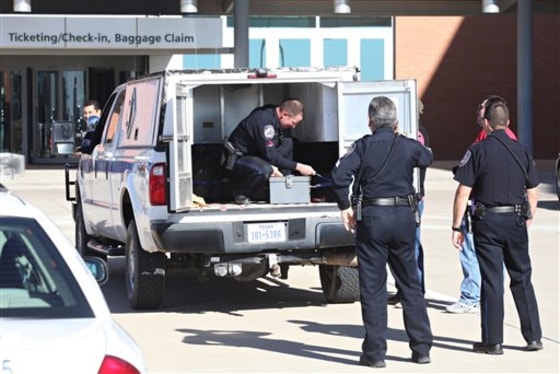Patrol Officer and Explosive Ordnance Technician Dylan Hale, left, secures an explosives transport box to the back of a vehicle to be taken to a storage facility, Saturday, Dec. 31, 2011, at the Midland International Airport in Midland, Texas. The military-grade explosives were confiscated from a departing passenger.